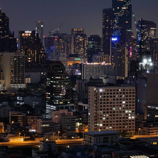 A city at night with a lot of tall buildings, illustrating clouds, mobility and security in Thailand