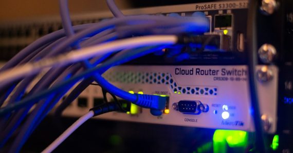 Close up of network cables connected to a switch, illustrating the state of cloud networking