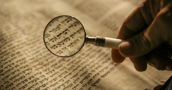 Person holding magnifying glass, illustrating vetting cloud provider partners