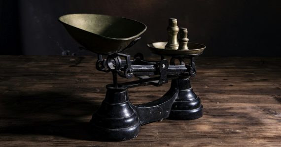 A scale with a bowl on top of it, illustrating the risks and benefits of cloud life