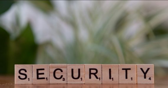 A wooden block spelling security on a table, illustrating cloud security for SaaS, PaaS and IaaS