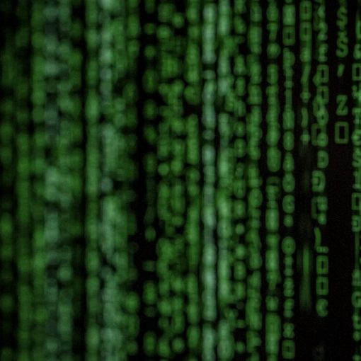 Columns of glowing green digital code on a dark background, illustrating improving security in the cloud