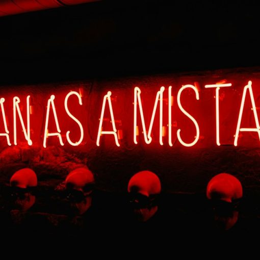 A neon sign that says it began as a mistake, illustrating common cloud security mistakes