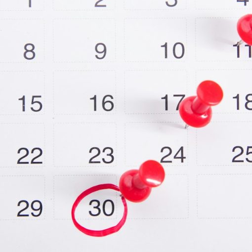A calendar with red push buttons pinned to it, illustrating small businesses planning cloud adoption