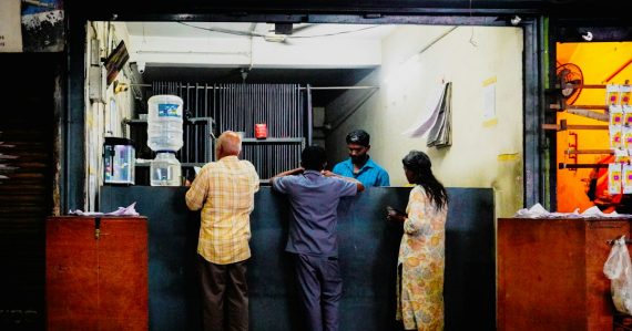 Customers interact with a vendor at a street shop, illustrating users demanding more from cloud providers