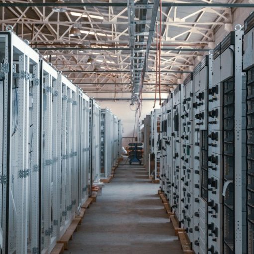Server room aisle lined with metal equipment racks, illustrating the cloud storage battle