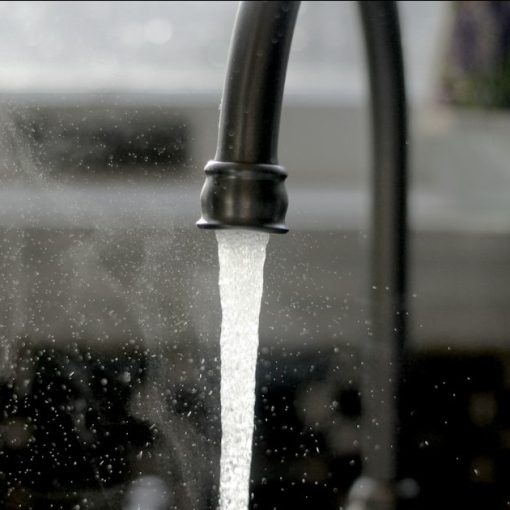A faucet running water into a sink, illustrating cloud computing as a utility