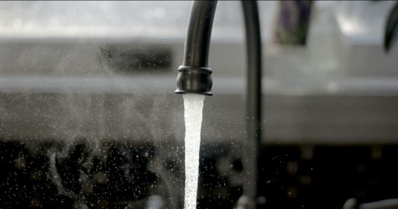 A faucet running water into a sink, illustrating cloud computing as a utility