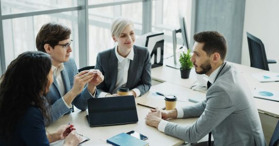 Diverse business team collaborating in a modern office, illustrating vetting cloud vendor security