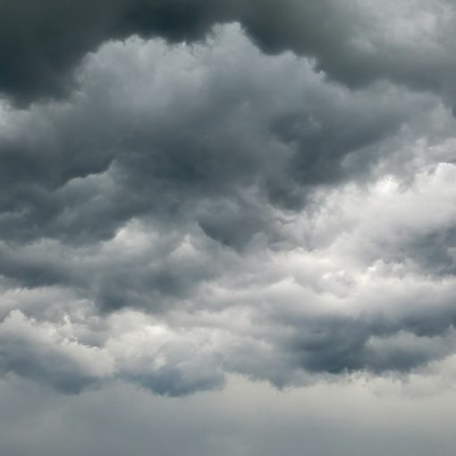 Dense dark grey storm clouds filling the sky, illustrating Color app and social clouds