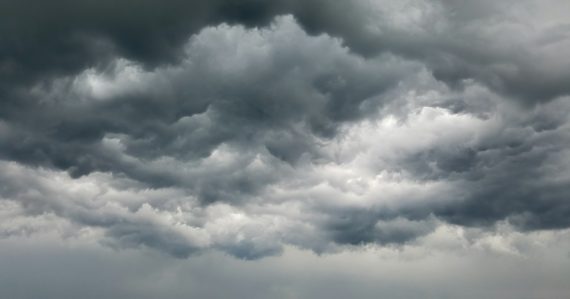 Dense dark grey storm clouds filling the sky, illustrating Color app and social clouds