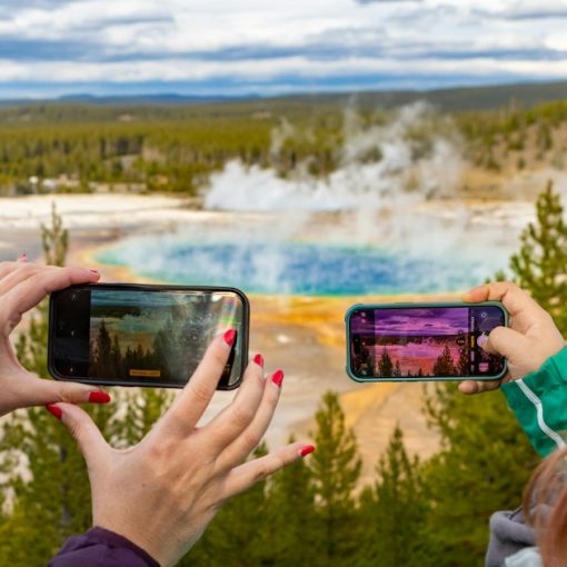 Two people taking photos of a hot spring, illustrating the Color mobile social network