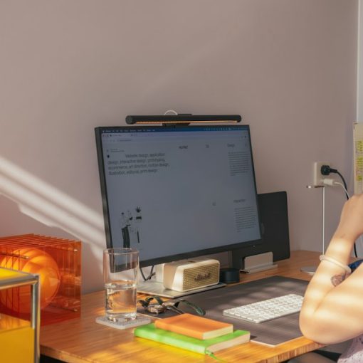 A person wearing headphones at a desk with a computer in a home office, illustrating contact centers adopting home working