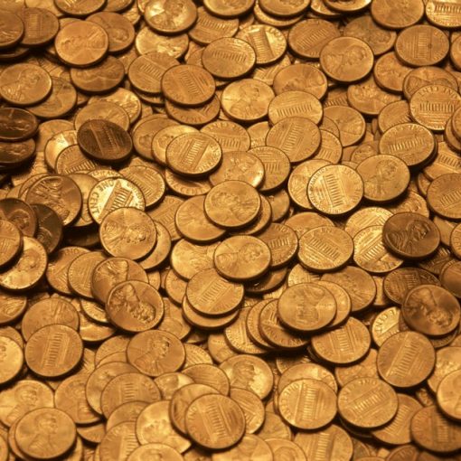Brown round coins on brown wooden surface, illustrating lowering cloud storage costs
