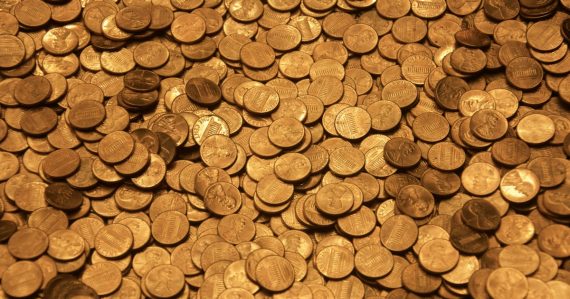 Brown round coins on brown wooden surface, illustrating lowering cloud storage costs