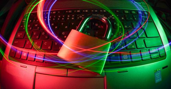 Padlock on laptop with light trails, illustrating the Dallas cybersecurity industry