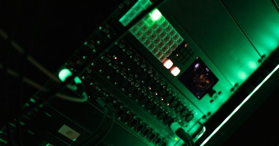A close up of a computer in a dark room, illustrating federal data center consolidation