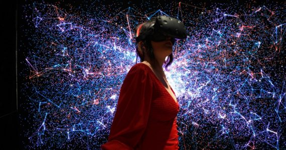 A woman in a red dress wearing a virtual reality headset, illustrating virtual desktops