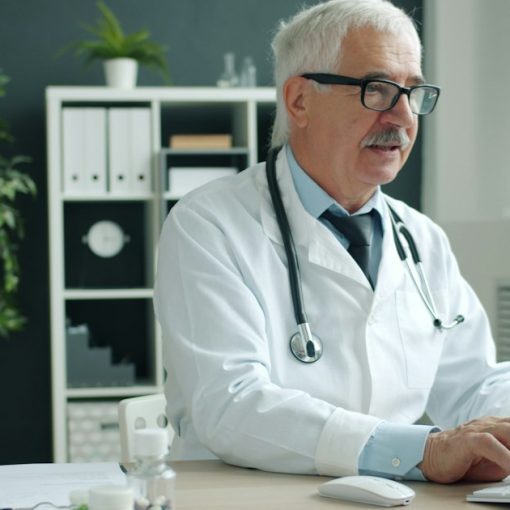 Doctor typing on computer in office, illustrating healthcare leading desktop virtualization adoption