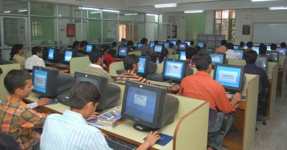 People working at desktop computers in a bright workspace, illustrating desktop virtualization