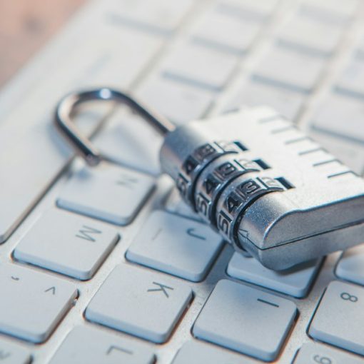 A combination lock rests on a computer keyboard, illustrating desktop virtualization improving security