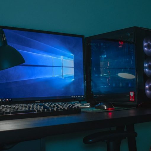 Desktop computer set with a black and gray leather chair, illustrating desktop virtualization