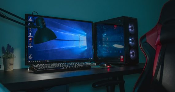 Desktop computer set with a black and gray leather chair, illustrating desktop virtualization