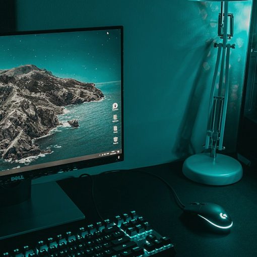 Black flat screen computer monitor beside black computer keyboard, illustrating desktop virtualization versus VDI