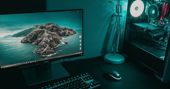 Black flat screen computer monitor beside black computer keyboard, illustrating desktop virtualization versus VDI