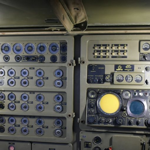 Complex control panel with many buttons and screens, illustrating Department of Defense cloud computing