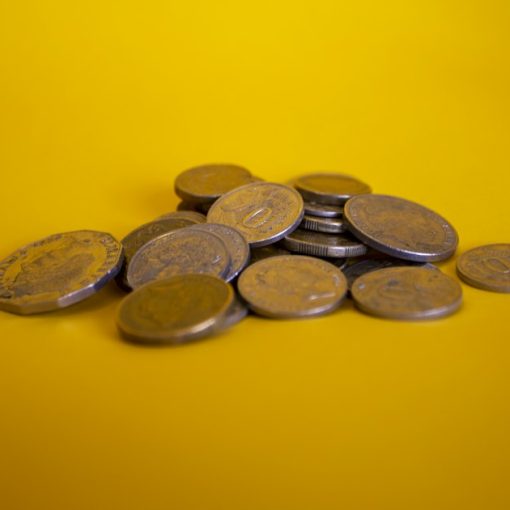 Gold and silver round coins, illustrating economic benefits of cloud computing