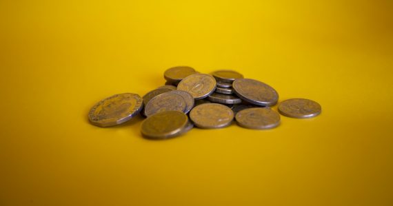 Gold and silver round coins, illustrating economic benefits of cloud computing