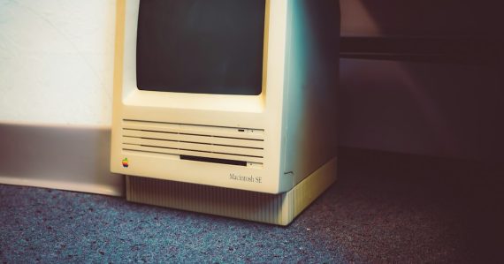 An old computer sitting on the floor next to a wall, illustrating the cloud replacing the PC