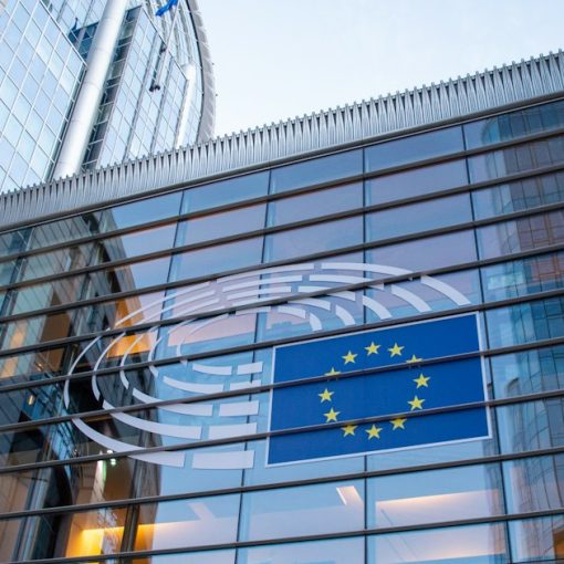 European Union flag reflected on modern building glass, illustrating ENISA's cloud computing security report