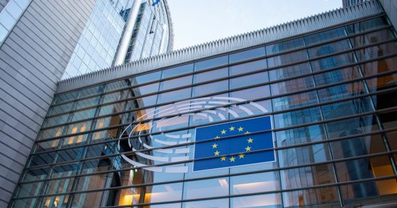 European Union flag reflected on modern building glass, illustrating ENISA's cloud computing security report