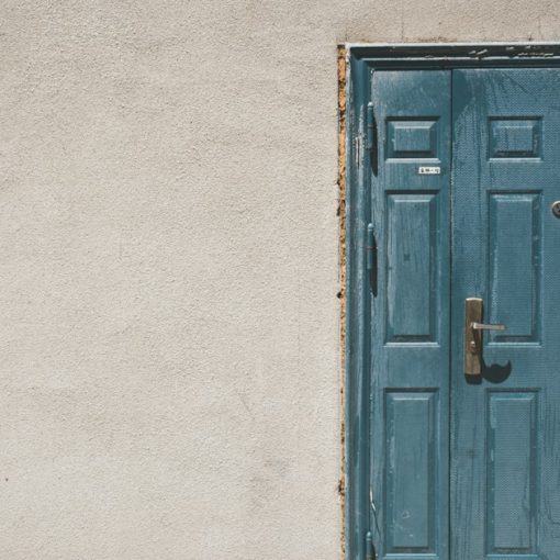 Closed door and white painted wall, illustrating entering the cloud
