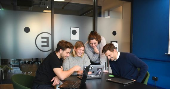 People sitting on chair in front of laptop computers, illustrating enterprise application strategy with the cloud