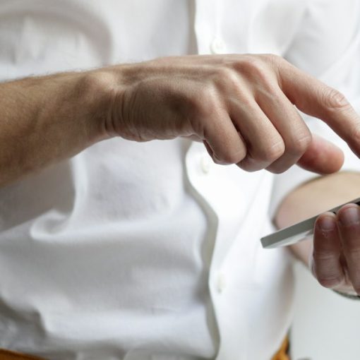 Person holding white Android smartphone, illustrating linking personal mobile devices to enterprises