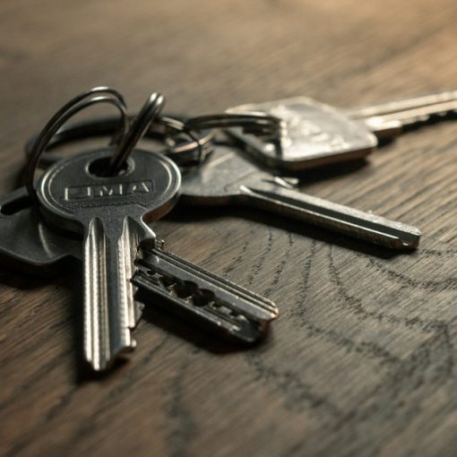 A bunch of keys sitting on top of a wooden table, illustrating enterprise use of the public cloud