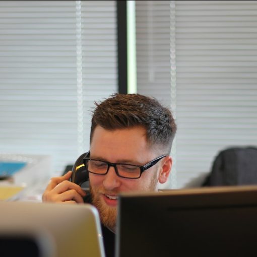 Man using IP phone inside room, illustrating enterprise VoIP decisions