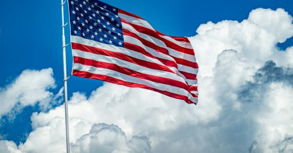 An american flag flying high in the sky, illustrating EU and US cooperation on cloud computing