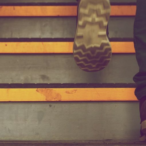 Person walking up a flight of steps, illustrating five steps to implement cloud computing