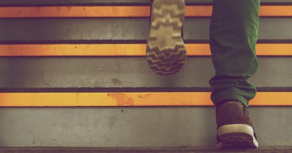 Person walking up a flight of steps, illustrating five steps to implement cloud computing