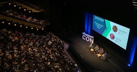 A panel discussion on a stage in a large auditorium with an audience, illustrating Vint Cerf's view of the cloud's future