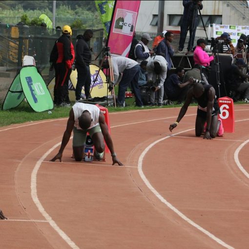 Athletes in starting blocks on a race track, illustrating getting started with cloud computing