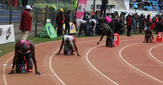 Athletes in starting blocks on a race track, illustrating getting started with cloud computing