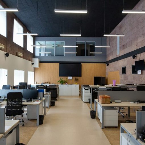 An open plan office with rows of desks and computers, illustrating government cuts driving cloud and outsourcing