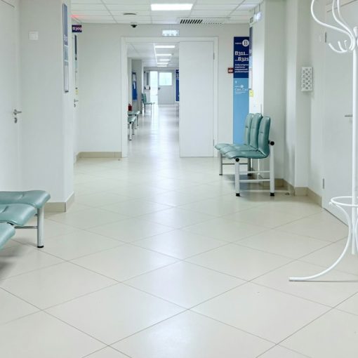 Empty hospital corridor with benches and doors, illustrating healthcare slow to adopt the cloud