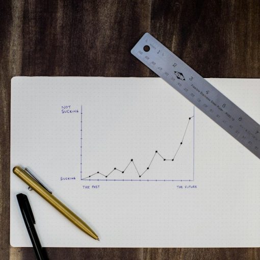 A hand-drawn growth graph on paper with a ruler and pens, illustrating how the cloud helps businesses grow