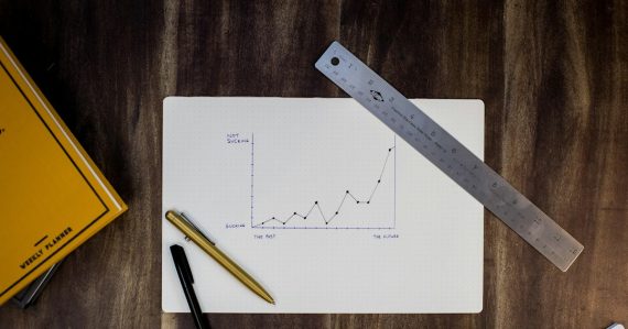 A hand-drawn growth graph on paper with a ruler and pens, illustrating how the cloud helps businesses grow